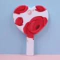 Detailed view of a portable heart-shaped handheld makeup mirror with red rose print design - 12.5cm*18cm / Heavenly Beauty