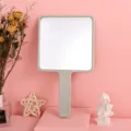 Large square handheld makeup mirror with sleek grey handle for daily vanity use - Light Green