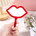 Red lip-shaped handheld makeup mirror with portable handle for daily beauty use. - Without Pattern / 12*16cm / Red