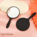 Round handheld makeup mirror 7.5cm x 13.5cm featuring a sleek black matte handle - 5.5x10cm / Black