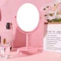 Minimalist pink rotating desktop makeup mirror for vanity table with a sleek oval design - Large (Double-Sided 2x Zoom) / Pink