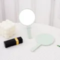 Elegant mint green handheld round makeup mirror displayed on a white aesthetic background - 7.5*13cm Round Mirror / Light Green