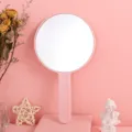 Large pink handheld round makeup mirror with ergonomic handle for vanity and travel - 12cm*21cm / Pink