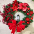 Exquisite Christmas wreath featuring red poinsettias, berries, large bow and lantern - Red Flower Lantern Style / 25cm Size