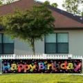 Colorful Happy Birthday banner for outdoor yard party decoration displayed on white fence - SHF-007 / Colorful Dots & Stars Birthday Theme (SHF-007) / 30x120cm (With Holes and Rope)