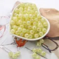 Macro detail of yellow acrylic bubble beads with crackle effect for DIY jewelry making - Yellow