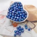 Close-up detail of deep blue acrylic bubble beads with vibrant iridescent AB finish for DIY crafts - Sapphire Blue