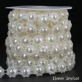 Close-up detail of 15mm cream white flower-shaped ABS pearl bead chain on a spool - Floral / 15mm 2m Pack / Beige