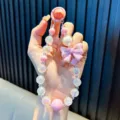 Handgefertigter eleganter rosa Perlen-Handygurt mit schillernden Perlen und großer Schleife - Mit Handy-Pad / Rosa