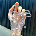 Glitzernder lavendelfarbener Kristall-Schleifen-Handyanhänger mit Perlen und Perlenkette - Lila