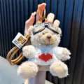 Adorable plush teddy bear keychain featuring pilot glasses and a white heart sweater - Brown Bear - White Sweater