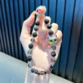 Handmade beaded keychain with a cartoon cat head and shiny black rhinestones. - Black