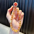 Élégant cordon de téléphone en perles de cristal ambre avec attache en anneau argenté - Orange