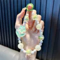 Luminous mint green flower beaded phone charm strap with elegant pearlescent beads. - Includes Gasket / Green
