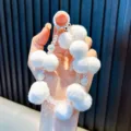White fluffy pom-pom phone strap featuring crystal beads and a white ring clasp for accessories - White