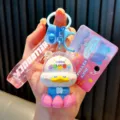 Cute cartoon Buddha duck keychain with Good Luck message and pink lotus base - Pink