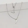 Detail showing a minimalist white enamel chili pendant on a stainless steel bead chain. - 45+5cm / White
