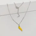 Detailed macro view of a silver stainless steel necklace with yellow chili pendant - 45+5cm / Lemon Yellow