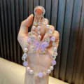 Elegant purple crystal butterfly beaded phone charm with pearls and sparkling stones - Purple