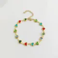 Detail of a stainless steel anklet featuring vibrant heart-shaped colorful crystals. - Multicolor