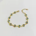 High-quality detailed view of gold stainless steel bracelet with elegant blue heart charms - Sapphire Blue