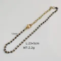 Detail view of gold stainless steel anklet with black beads and 23+5cm length specs - Steel / Black