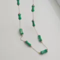 Macro detail of green bamboo-shaped resin beads on a delicate gold stainless steel chain - Dark Green