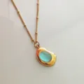 Close-up of a vintage 18K gold plated stainless steel necklace with blue stone - Light Blue