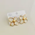 Detailed view of vintage stainless steel flower stud earrings with white enamel glaze - White