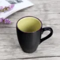 Japanese matte black ceramic mug with green crackle glaze interior and comfortable handle. - Yellow