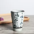 Detail view of Japanese ceramic tea cup with hand-painted blue floral patterns - 201-300ml / Winter Plum