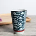 Detailed view of traditional Japanese ceramic tea cup featuring blue plum blossom patterns - 201-300ml / Multicolor Blue Glow