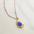 Detailed view of vintage 18K gold plated necklace with a brilliant blue oval stone - Dark Blue