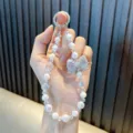 Elegant handmade phone strap featuring a sparkling rhinestone bow and white luster pearls - 1 Piece/Pack (With Gasket) / White