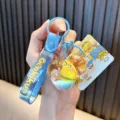 Cute yellow duck drifting sand gourd keychain with blue silicone Genki kun hand strap - Blue