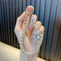 Exquisite silver rhinestone-encrusted bear phone charm with sparkling heart gem - White