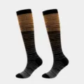 Detailed view of knee-high compression socks with orange and grey gradient stripes - S/M / Orange And Dark Gray