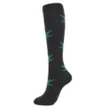 Black compression knee-high sock with green leaf patterns shown on white background - Black Green Leaf