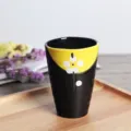 Macro view of a Japanese style ceramic matcha tea cup with delicate white flower pattern - 201-300ml / Black