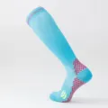 Detail view of light blue compression sports socks with red dot pattern and yellow accents - S/M / Light Blue