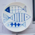 Minimalist Nordic white ceramic dining plate with three hand-drawn blue fish patterns - 10 inch Fish Pattern Plate