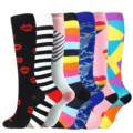 Variety of colorful knee-high compression socks with patterns for sports and running. - 7 Pairs Mixed Set 2