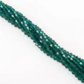 Detailed close-up shot of teal faceted bicone crystal beads for DIY handmade jewelry making - 115 Pieces/Pack / Peacock Green