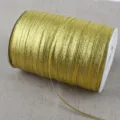 Detail view of a roll of sparkling gold metallic ribbon cord for DIY hair accessories. - 4mm 20 Yards Pack / Gold