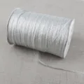High-quality detail view of a silver metallic glitter ribbon roll for various DIY crafts - 4mm 20 Yards Pack / Silver