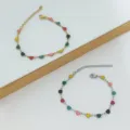 Detailed view showing a gold and silver stainless steel bracelet with colorful heart charms - Multicolor