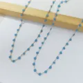 Detail of two stainless steel necklaces with blue enamel heart charms in gold and silver - Teal