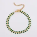 Elegante bracciale a spina di pesce in acciaio dorato con dettagli in smalto verde - Collana / Verde