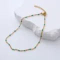 Detail view of a gold-plated stainless steel anklet with vibrant green enamel beads for women - 23+3cm / Green