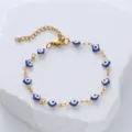 Macro view of gold stainless steel Turkish evil eye bracelet with blue enamel beads - Blue